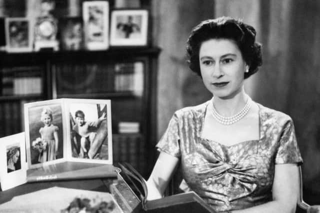 File photo dated 25/12/57 of Queen Elizabeth II, in the Long Library at Sandringham, after making the first televised Christmas day broadcast to the nation. The Queen is holding the copy of 'Pilgrim's Progress', from which she read a few lines during her message.