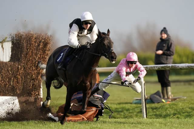 Third Time Lucki ridden by Harry Skelton (left) clears a fence before going on to win the Watch Off The Fence On attheraces.com Lightning Novices' Chase, as For Pleasure ridden by jockey Harry Bannister are fallers at Doncaster Racecourse. Both horse and rider were unscathed.