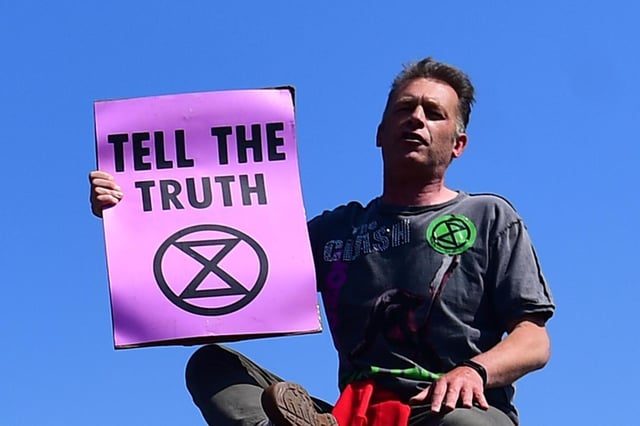 Chris Packham in 2019 giving a speech atop a bus stop during the Extinction Rebellion protest on Waterloo Bridge in London.  Photo: Victoria Jones/PA Archives/PA Pictures.