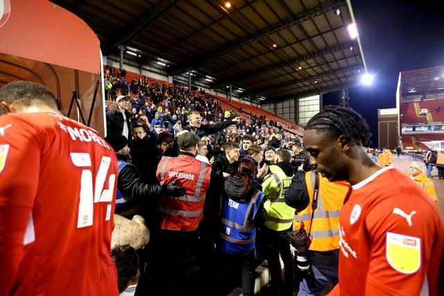 Dejected Barnsley players depart down the tunnel in front of elated Cardiff City fans (PA)
