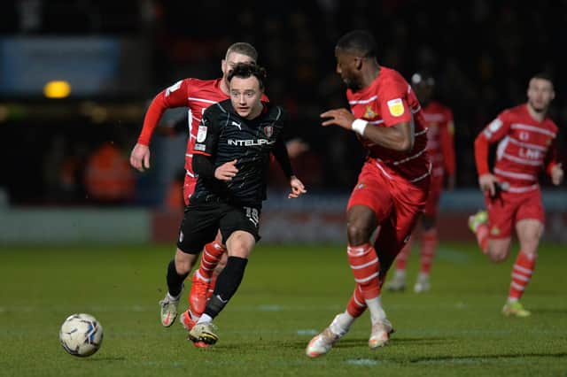 Rotherham United's Oliver Rathbone clears the ball down the line from Joseph Olowu in Tuesday night's win over Doncaster Rovers. Picture: Bruce Rollinson