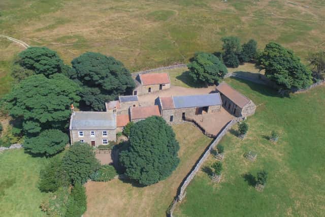 An overhead shot of the historic farmstead with farmhouse and farm buildings