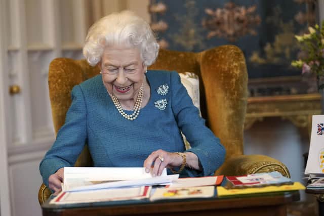 .Queen Elizabeth II views a display of memorabilia from her Golden and Platinum Jubilees in the Oak Room at Windsor Castle.