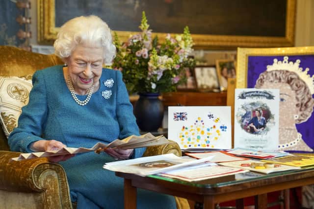 .Queen Elizabeth II views a display of memorabilia from her Golden and Platinum Jubilees in the Oak Room at Windsor Castle.