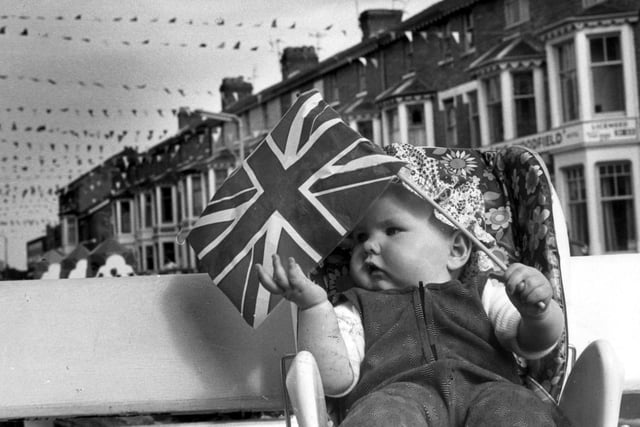 Seven-month-old Kerry Parkinson waving the Union Jack for Woodfield Road, South Shore.