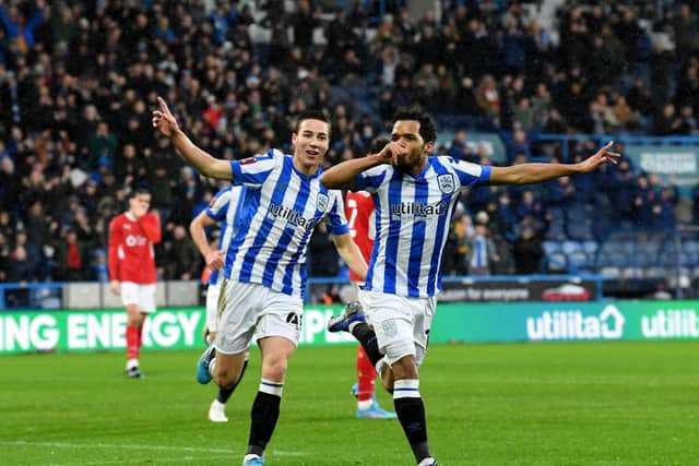 Duane Holmes celebrates scoring the only goal of the game for Huddersfield with team-mate Carel Eiting. Picture: Simon Hulme.