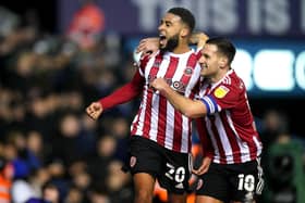LATE WINNER: Sheffield United's Jayden Bogle (left) celebrates scoring the Blades' second goal of the game with team-mate Billy Sharp during the Sky Bet Championship match at St Andrew's, Birmingham. Picture: Mike Egerton/PA Wire.
