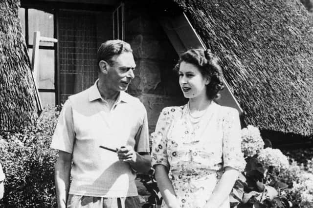 King George VI relaxing with his daughter Princess Elizabeth during a visit to Natal National Park in South Africa