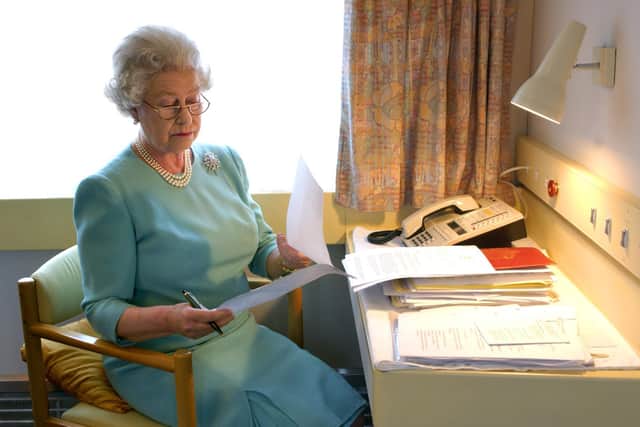 Elizabeth II at work aboard the Royal train near Darlington during her Golden Jubilee tour of the UK in 2002