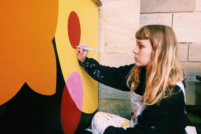 Left Bank Leeds - artist and illustrator Megan Dobbyn, who runs workshops at LBL, painting murals at the venue.