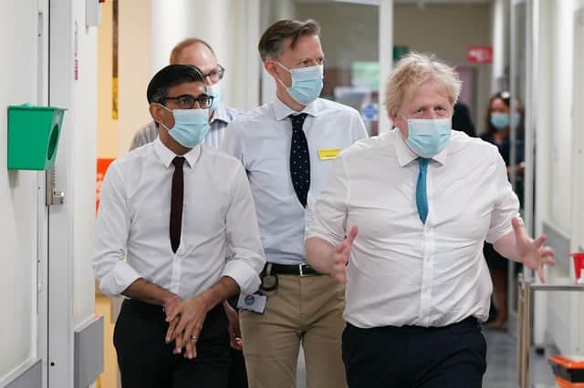 Prime Minister Boris Johnson (right) and Chancellor of the Exchequer Rishi Sunak (left) during a visit to the Kent Oncology Centre at Maidstone Hospital in Ken