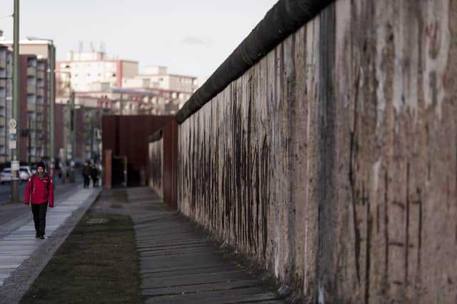 A visitor walks along the Berlin Wall memorial at Bernauer Strasse on February 5, 2018 in Berlin, Germany. Picture: Carsten Koall/Getty Images.