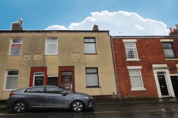 This mid-terrace is "a short walk from Preston city centre" and is on the market with Strike for £80,000