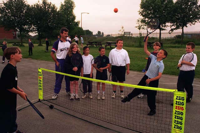 Brian Wallwork, racket sports development officer for Leeds Leisure Services coaching pupils at Manston Primary School in June 1997. Pictured battling it out over the net is Danny Driscoll (left) and Damian Lambert.