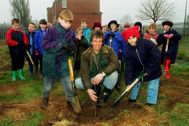 Community woodland officer Glen Gorner, helps Paul Tobin (left) and Victoria Whitaker (right) plant a tree at Manston Primary School in March 1996.