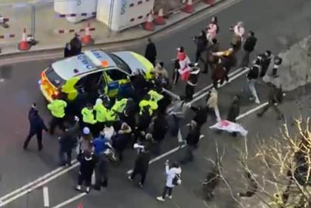 Video grab image courtesy of Conor Noon of clashes between police and protesters in Westminster as officers use a police vehicle to escort Labour leader Sir Keir Starmer to safety. Picture: PA