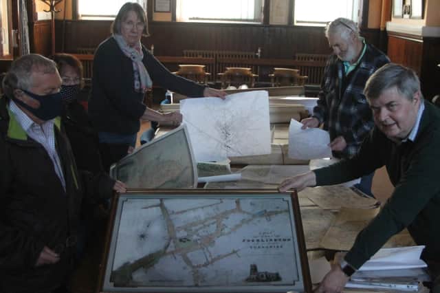 Pocklington and District Local History Group members (from left) David and Kay West, Jo and Peter Green and Andrew Sefton are pictured selecting historic local maps for the exhibition. Photo submitted