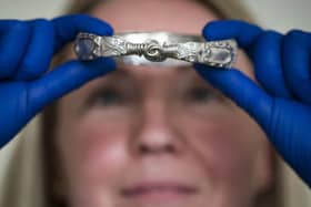 Jenny Truran, conservator at Lancashire County Museums Service, holds a Viking silver arm ring that would have acted as portable currency Picture: Danny Lawson/PA Wire