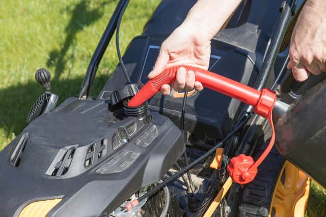 Petrol goes stale after about one month. Any fuel that is older than that will need to be drained off, and fresh petrol put in the tank. That should fix your lawnmower.