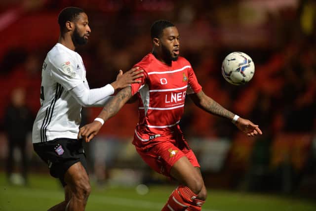 Reo Griffiths holds the ball from Janoi Donacien as Doncaster Rovers played Ipswich Town FC (Picture: Bruce Rollinson)
