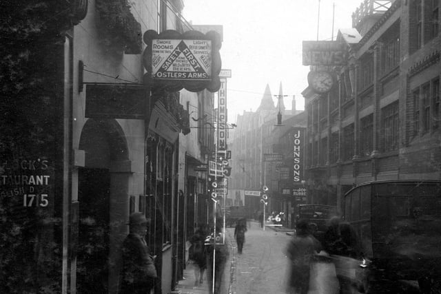 A view from Commercial Street to Boar Lane in May 1930. On the left is the Ostlers Arms pub. On the right can be seen a sign for Johnson's Engravers Ltd.