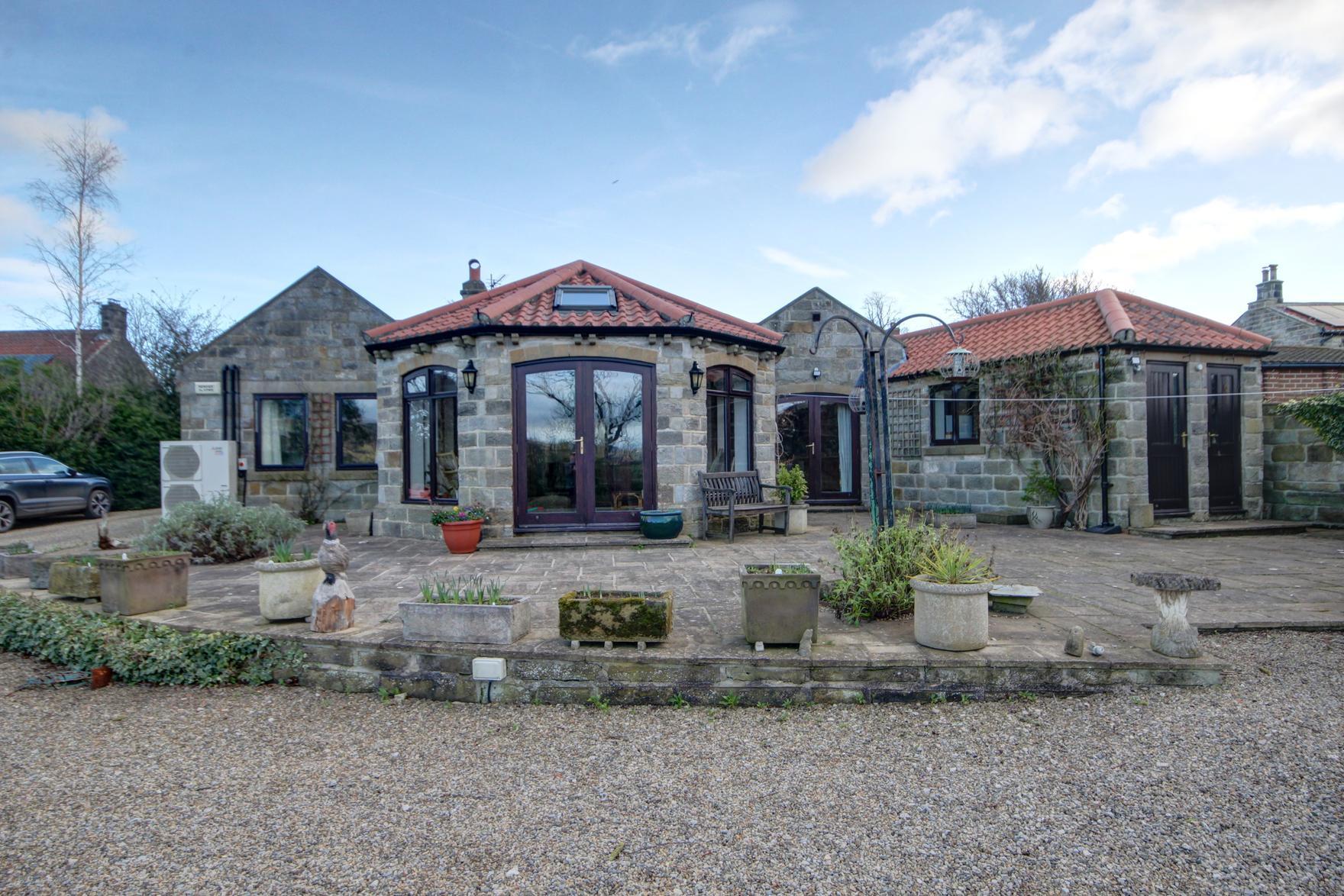 This home is attractive from all angles, with landscaped gardens.