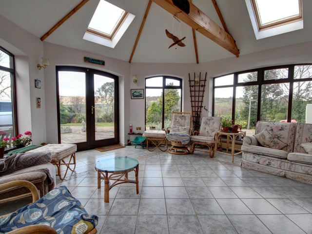 The light and spacious garden room has under floor heating.