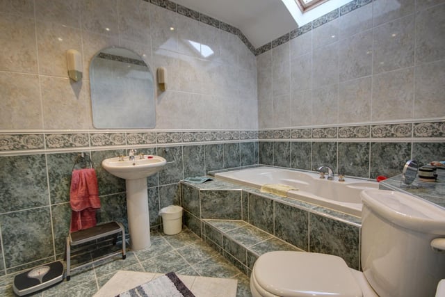 A jacuzzi spa bath is a luxury feature of the family bathroom, that also has a step-in shower.