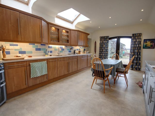 Fitted units and integral appliances line the walls of the recently refurbished dining kitchen.