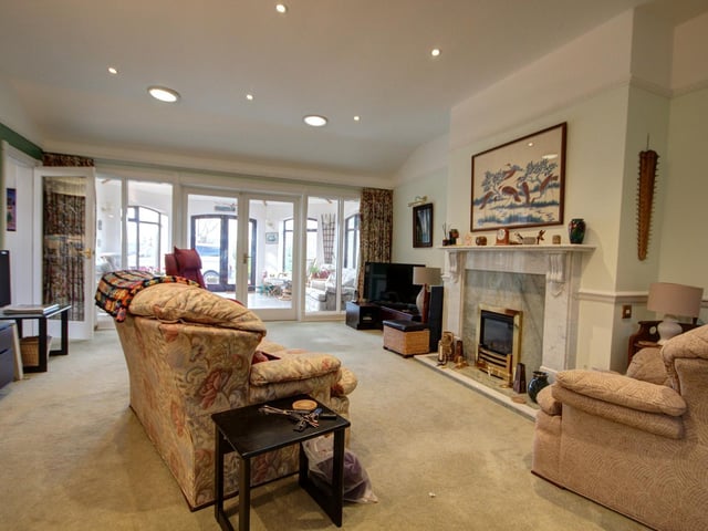 The feature fireplace is central to this spacious lounge.