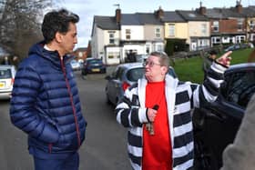 Shadow Energy and Climate Change Secretary Ed Miliband speaks to a local woman while canvassing for Labour votes on February 11, 2022 in Sheffield. (Photo by Anthony Devlin/Getty Images)