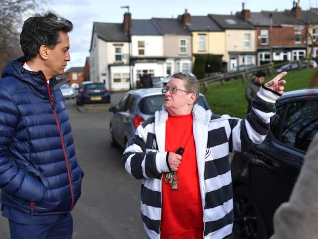 Shadow Energy and Climate Change Secretary Ed Miliband speaks to a local woman while canvassing for Labour votes on February 11, 2022 in Sheffield. (Photo by Anthony Devlin/Getty Images)