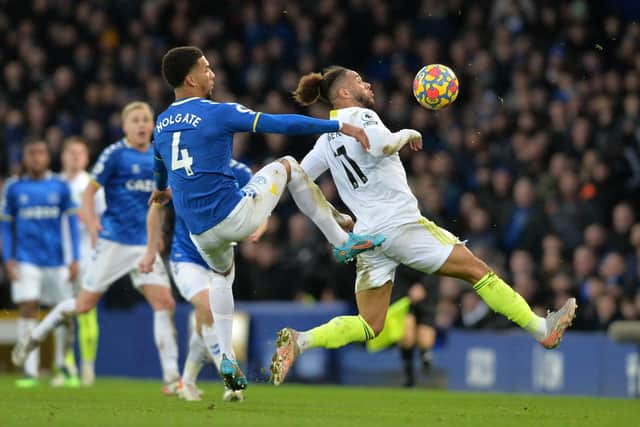 Tyler Roberts and Mason Mason Holgate challenge for the ball (Picture: Bruce Rollinson)