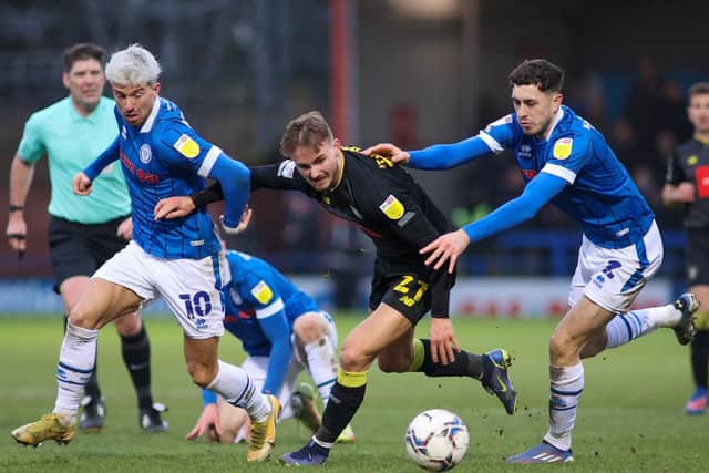 Jack Diamond is sandwiched by two Rochdale players.