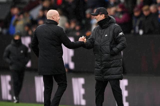 Jurgen Klopp, Manager of Liverpool shakes hands with Sean Dyche, Manager of Burnley prior to the Premier League match between Burnley and Liverpool at Turf Moor on February 13, 2022 in Burnley, England.