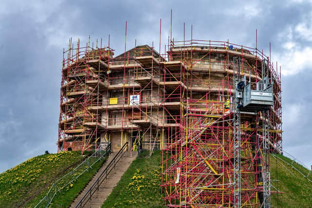 Scaffolding surrounds one of York's most famous landmarks, Clifford's Tower, which is due to re-open after undergoing a £5m restoration. The work includes installing new internal walkways and a roof deck to offer panoramic views across the city. (Photo: James Hardisty)