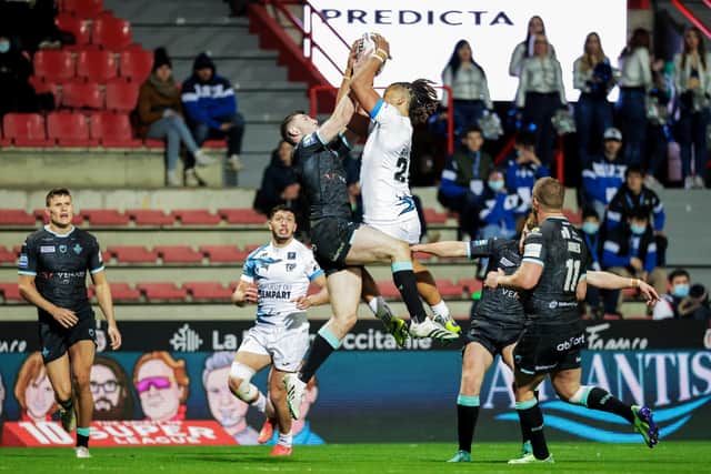 Huddersfield's Jake Wardle and Toulouse's Guy Armitage challenge for the ball in the air. (Picture: Alex Whitehead/SWpix.com)