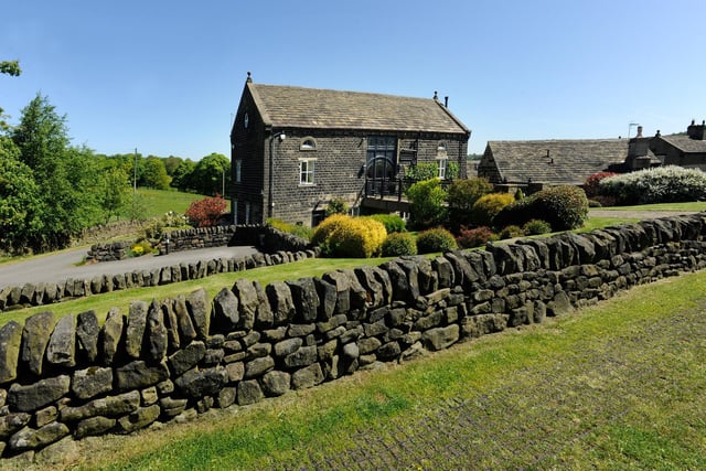 Greenery and stone walls surround the property