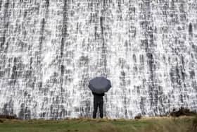 Water pours over the Derwent Dam in the Peak District ahead of the arrival of storms Dudley and Eunice.