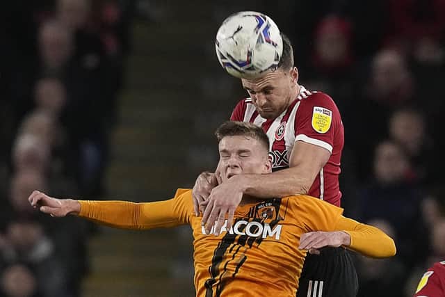 Unted's Jack Robinson heads the ball ahead of Marcus Forss of Hull City. Sheffield. Picture: Andrew Yates / Sportimage
