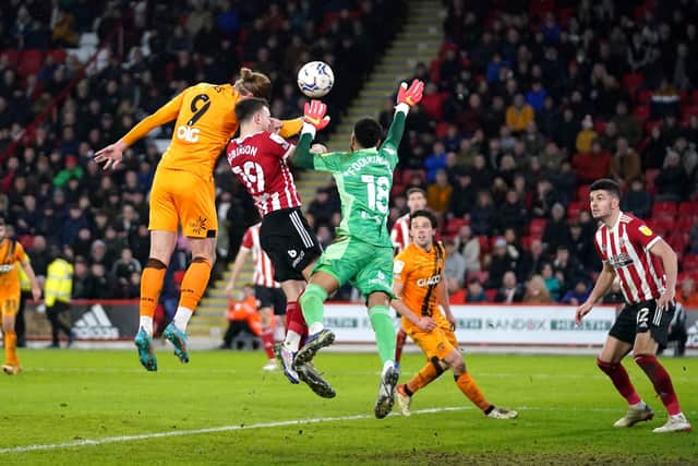 Hull City's Tom Eaves (left) attempts a header at goal. Picture: PA