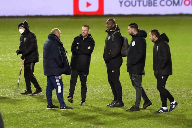 Match referee Ross Joyce  along with managers Owls Darren Moore and Stanley's John Coleman and other officals during the Hillsborough pitch inspection.    Picture: Seve Ellis