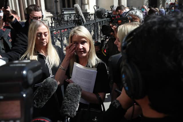 Former post office worker Janet Skinner (centre) speaks to the media outside the Royal Courts of Justice, London, after having her conviction overturned by the Court of Appeal.