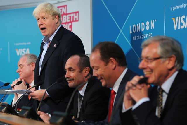 Mayor of London Boris Johnson (standing) is joined by (far left) Daniel Moylan, Chairman of the London Legacy Development Corporation, at an event related to the 2012 Olympics.