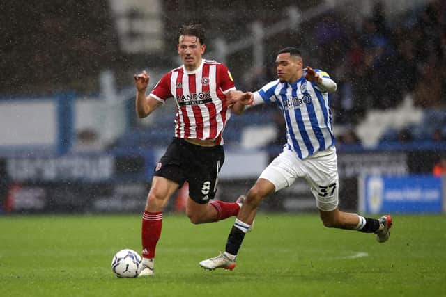 Sheffield United's Sander Berge (left) and Huddersfield Town's Jon Russell battle for the ball during the Sky Bet Championship match at John Smith's Stadium, Huddersfield. (Picture: PA)