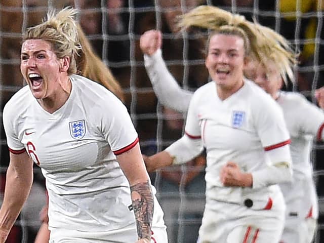 England's defender Millie Bright celebrates after scoring the opening goal against Canada. (Photo by OLI SCARFF/AFP via Getty Images)