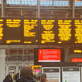 A sign at London's Paddington station shows cancelled trains after Storm Eunice hit the south coast, with attractions closing, travel disruption and a major incident declared in some areas urging people to stay indoors.