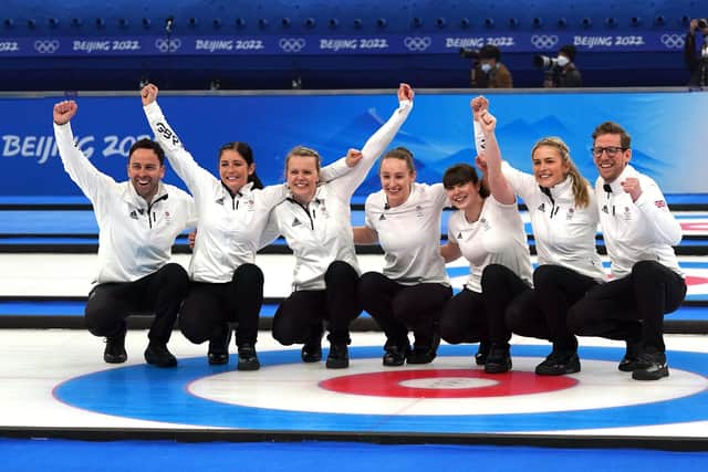 Great Britain coach David Murdoch, Eve Muirhead, Vicky Wright, Jennifer Dodds, Hailey Duff, Mili Smith and coach Kristian Lindstrom celebrate winning gold. Picture: Andrew Milligan/PA