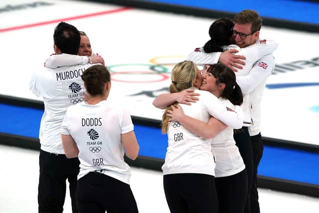 Great Britain coach David Murdoch, Eve Muirhead, Vicky Wright, Jennifer Dodds, Hailey Duff, Mili Smith and coach Kristian Lindstrom celebrate winning gold Picture: Andrew Milligan/PA