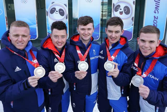 Great Britain's Bobby Lammie, Hammy McMillan, Bruce Mouat, Grant Hardie and Ross Whyte celebrate with their silver medals in Beijing. Picture: Andrew Milligan/PA